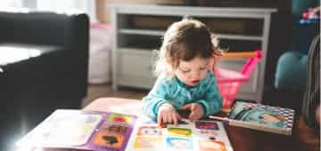Toddler reading a children's book